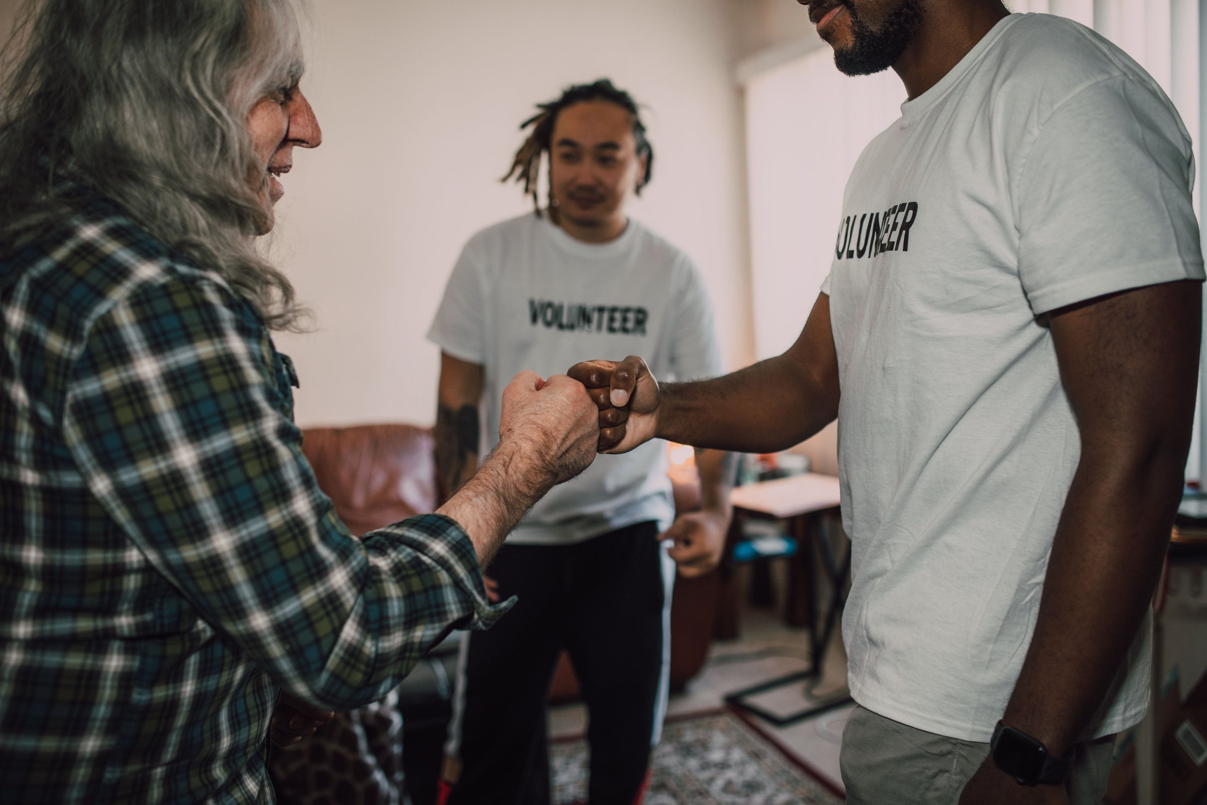 Volunteers joining fists together in partnership